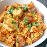 A white bowl with jambalaya with chicken and chorizo