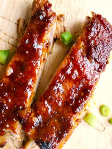 Overhead shoot of 2 pork ribs on a wooden board