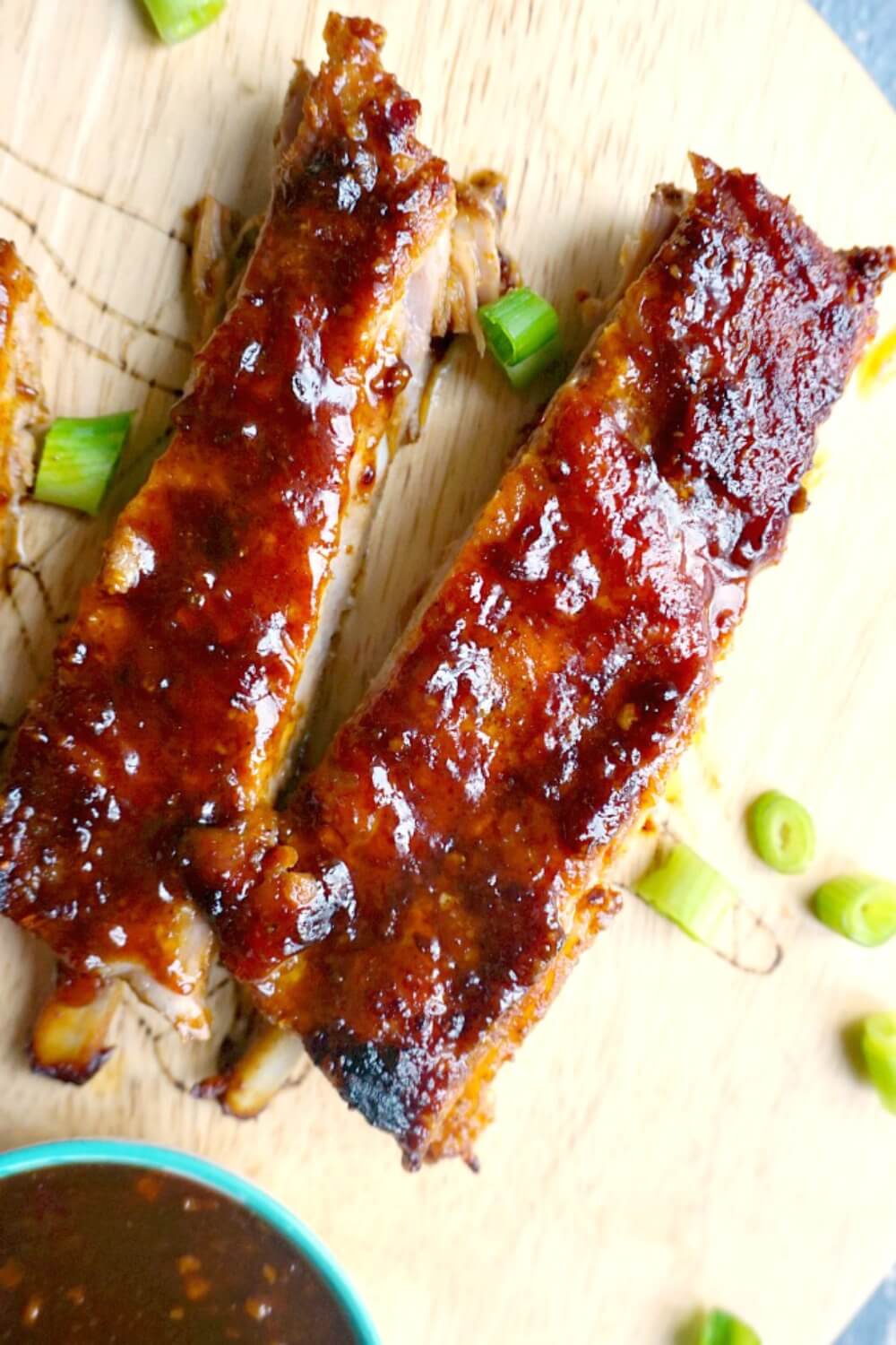 Easy Oven Baked Ribs with Sticky BBQ Sauce, the perfect finger food to feed a crowd. These pork ribs are perfect for Game Day or any other party or celebration. It might be a simple recipe, but these BBQ ribs are heavenly flavourful, and the Asian touch takes them to the very next level. The best ribs for Superbowl, they can be easily made with any other sauce of your choice. #porkribs, #bakeribs, #superbowlfood, #gamedayrecipes,#bbqsauce