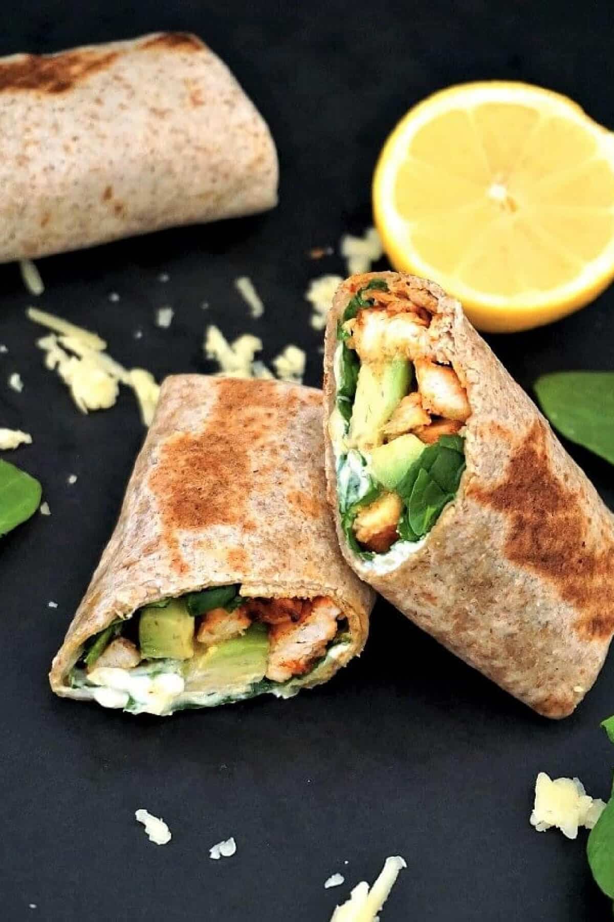 2 halves of a chicken and avocado wrap