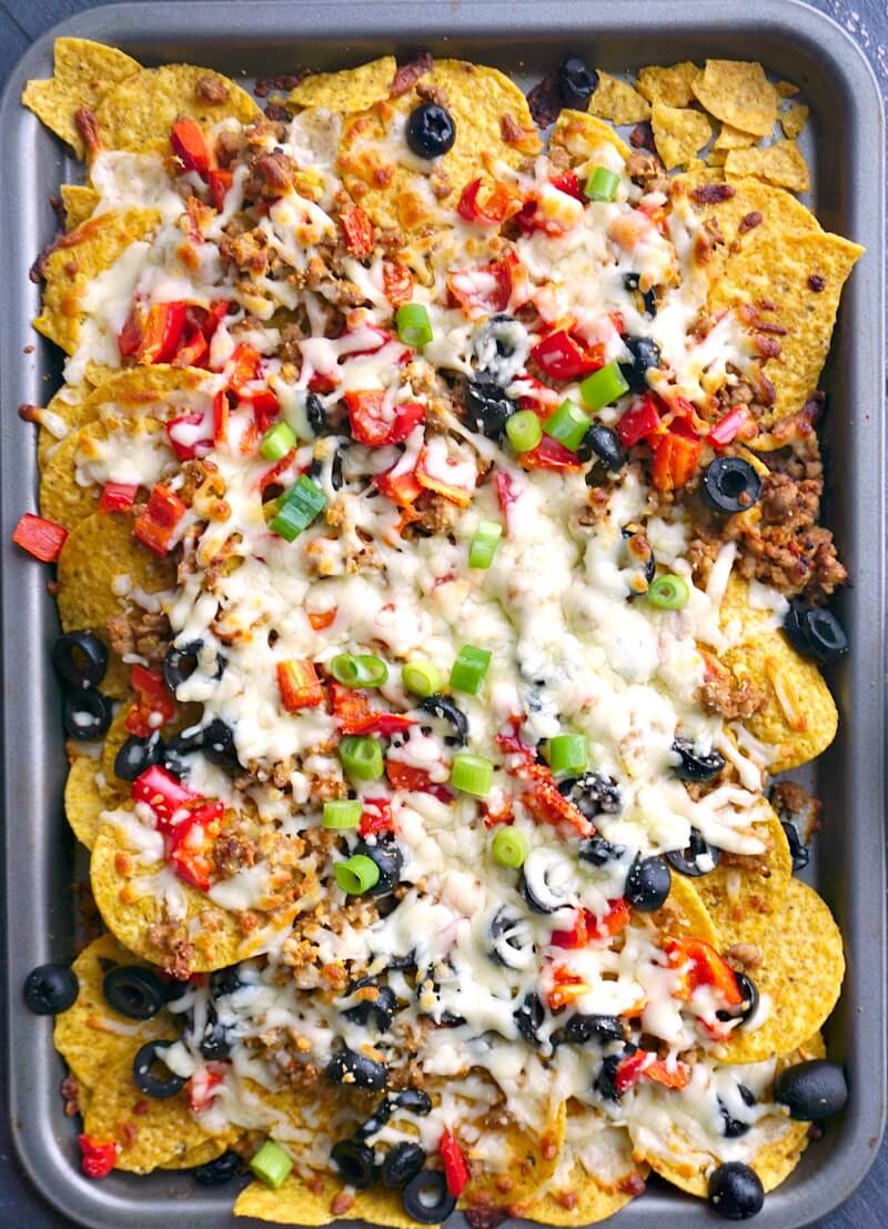 Overhead shoot of a tray with loaded ground pork nachos.