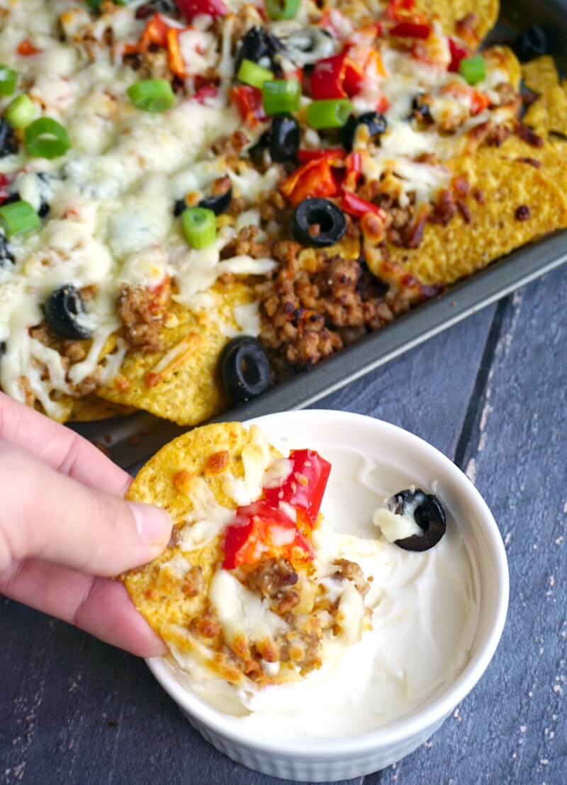 A tray and a white ramekin with nachos.