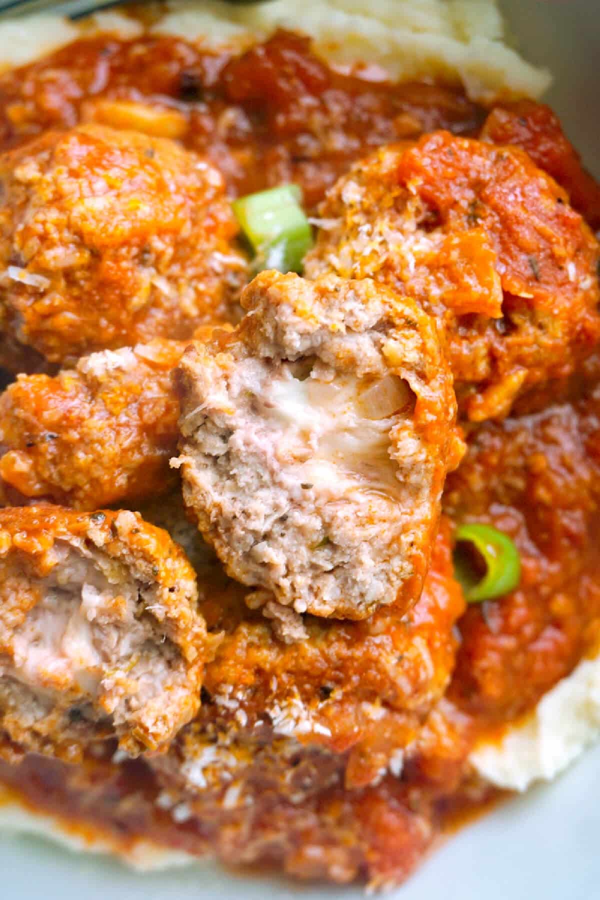 Close-up shoot of meatballs stuffed with mozzarella balls.