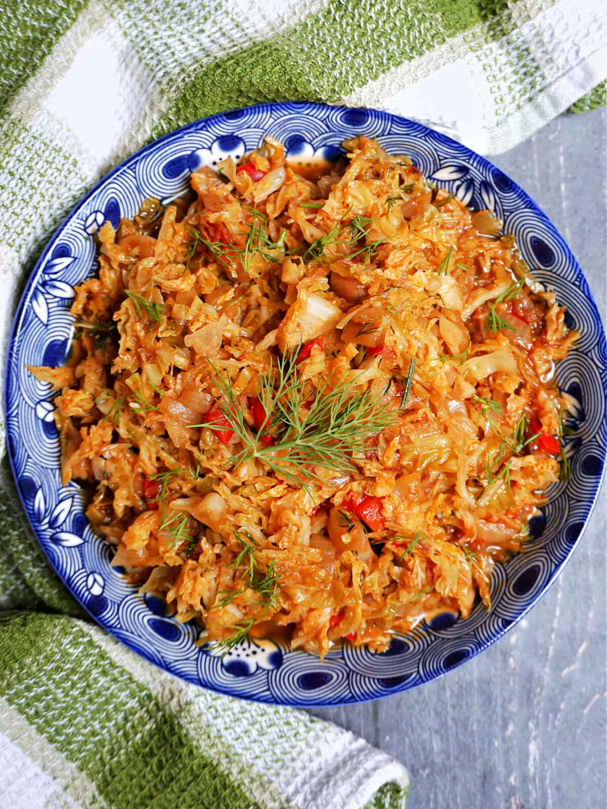 Overhead shoot of a blue bowl with stewed cabbage.