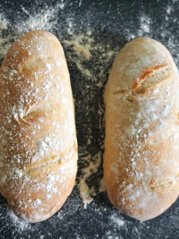 A baking tray with 2 mini bread loaves.