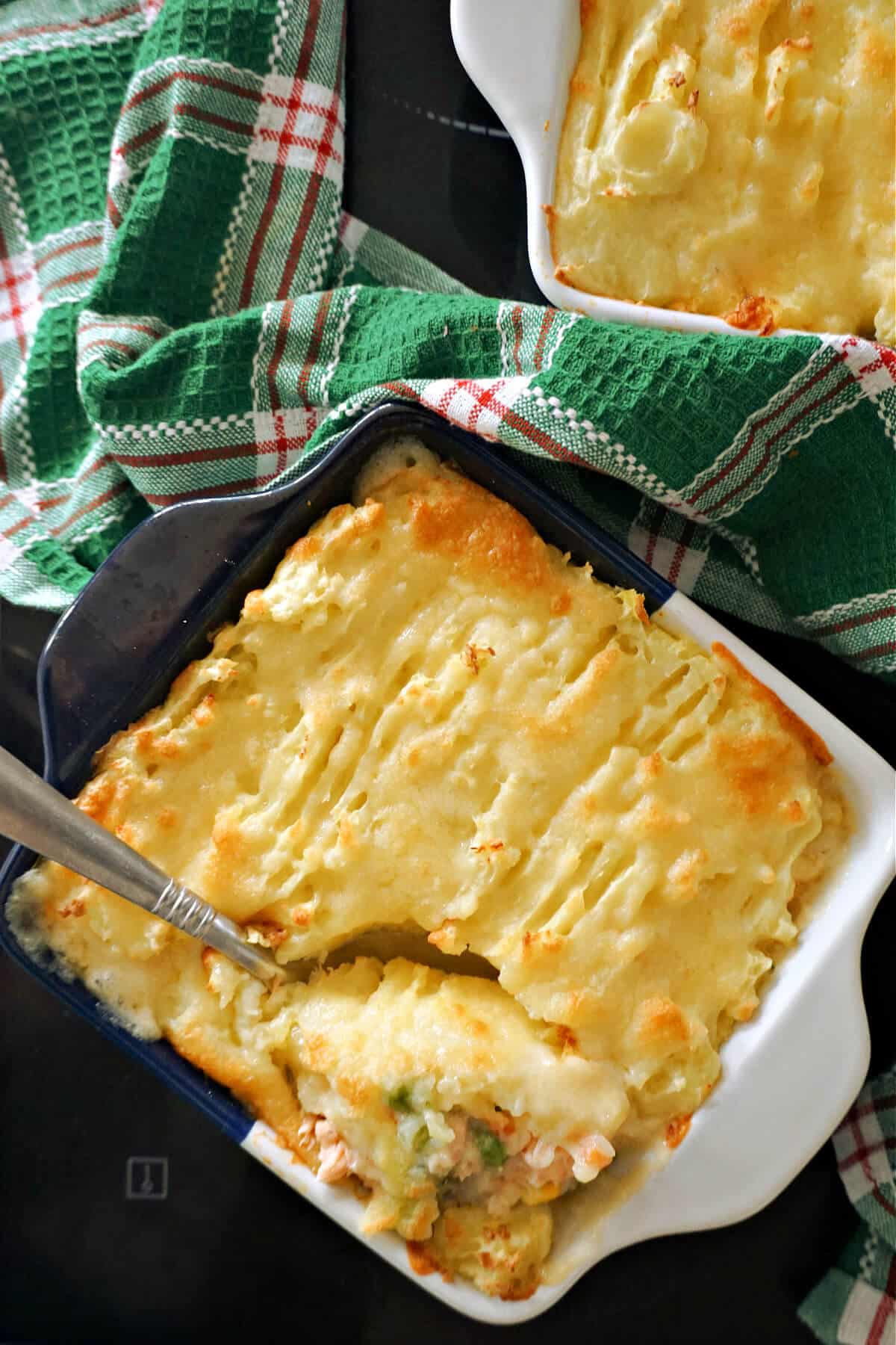 Overhead shoot of a dish with fish pie topped with mashed potatoes.