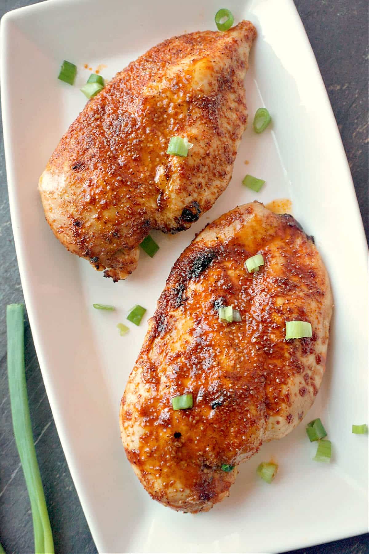 Overhead shoot of a white plate with 2 chicken breasts.