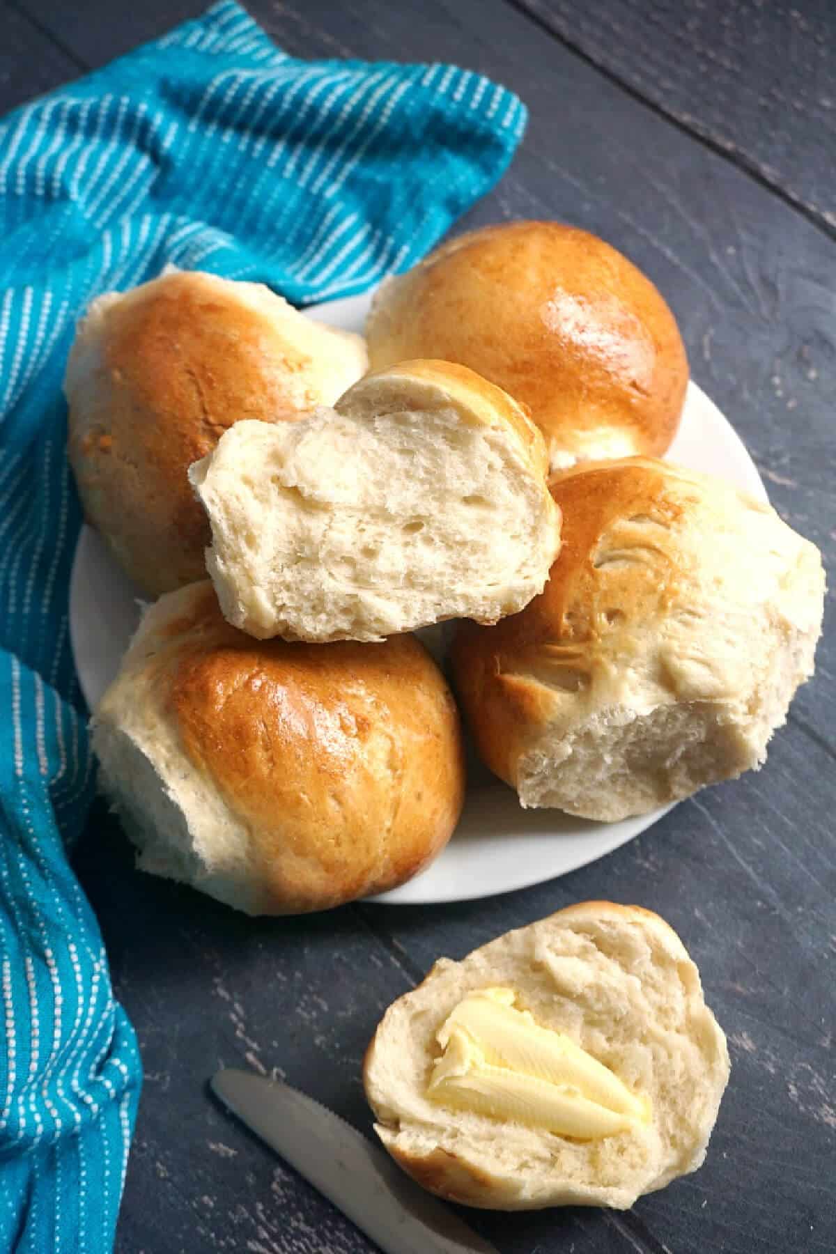 A white plate with bread rolls.