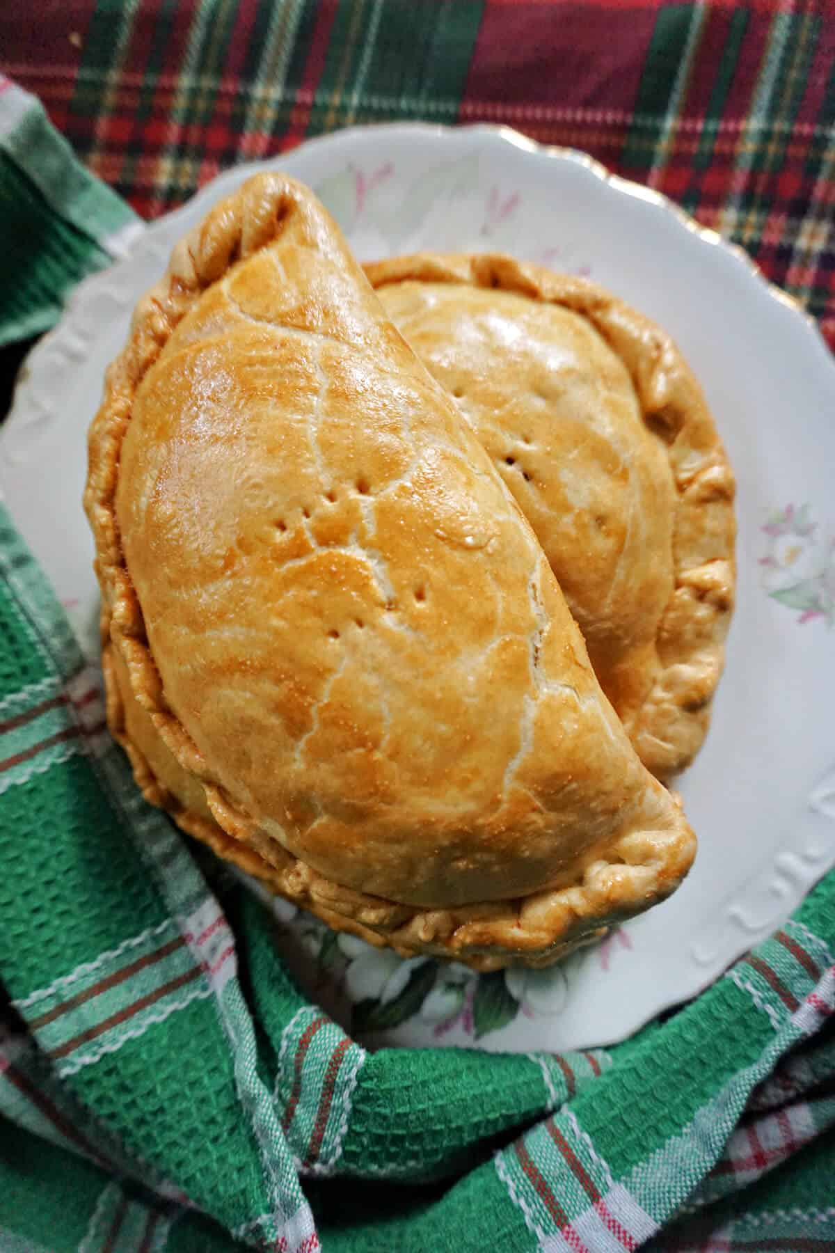 A white plate with 2 pasties.