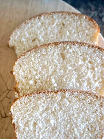 3 slices of bread on a wooden board