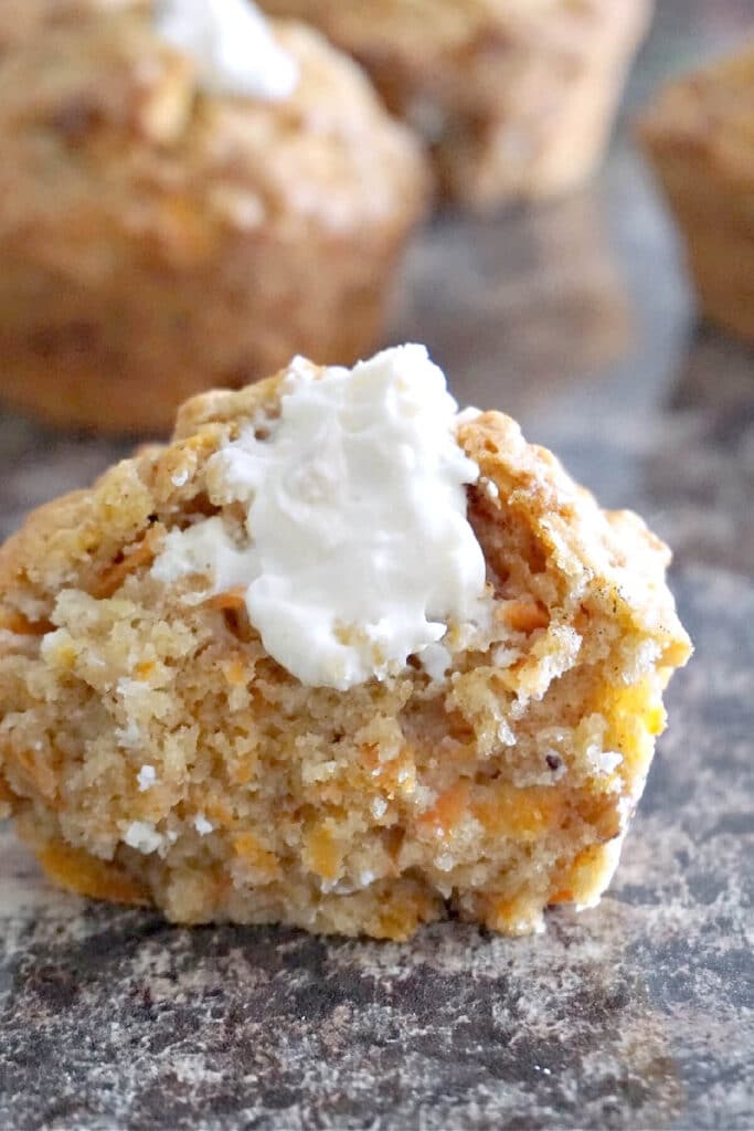 Half a carrot cake muffin filled with cream cheese