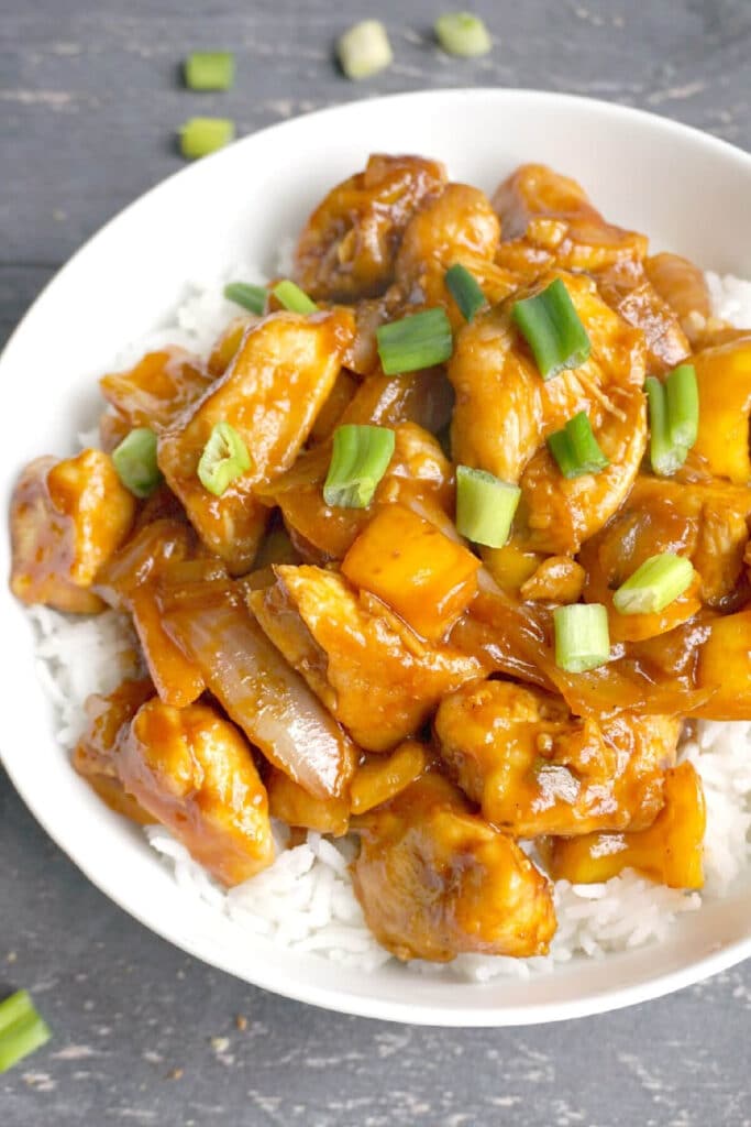 Overhead shoot of sweet and sour chicken over a bed of rice