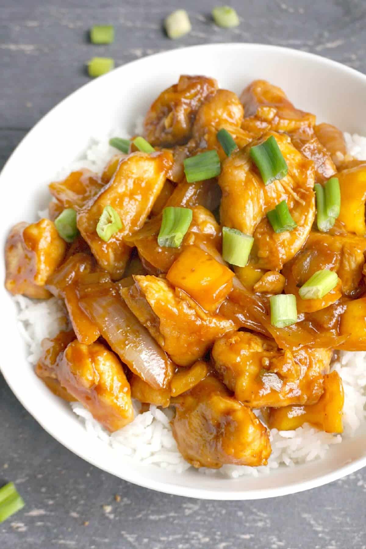 Overhead shoot of sweet and sour chicken over a bed of rice.