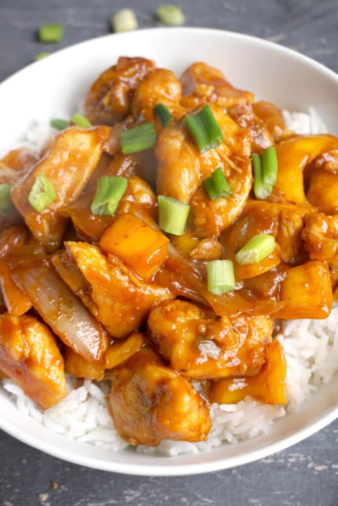 Close-up shoot of sweet and sour chicken over a bed of rice