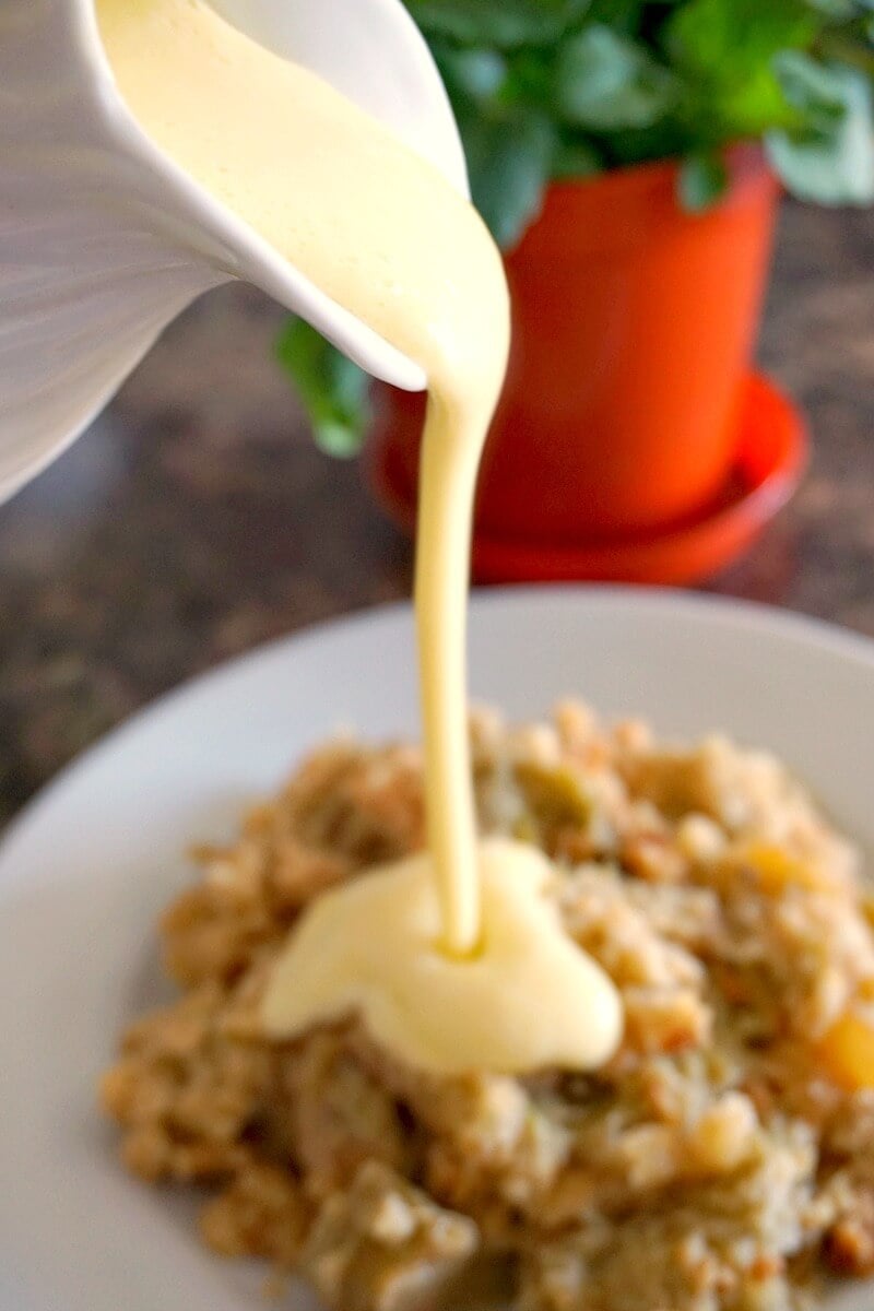 Custard being poured over a dessert.