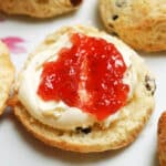 Half a scone topped with cream and jam