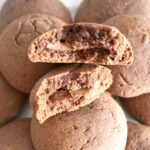 2 halves of nutella-stuffed nutella cookies on top of other cookies