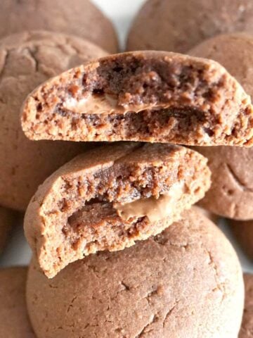 2 halves of nutella-stuffed nutella cookies on top of other cookies