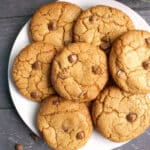 Overhead shoot of a white plate with 7 chocolate chip cookies