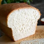 A sliced white bread on a wooden board