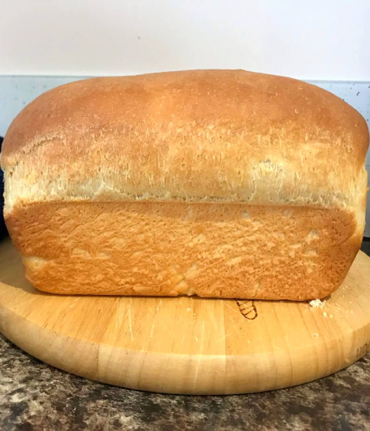 A loaf of bread on a wooden board.