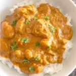 Overhead shoot of fish curry over a bed of rice