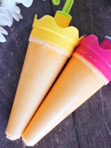 Overhead shot of 2 mango popsicles