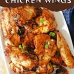 Baked chicken wings on a white plate.