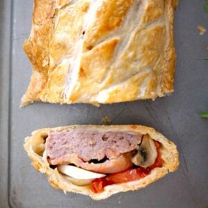 Overhead shoot of a roll on a baking tray and a slice next to it