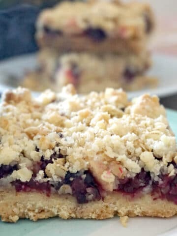 A slice of apple and blackberry crumble bar