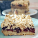 A fruit crumble bar on a light blue plate