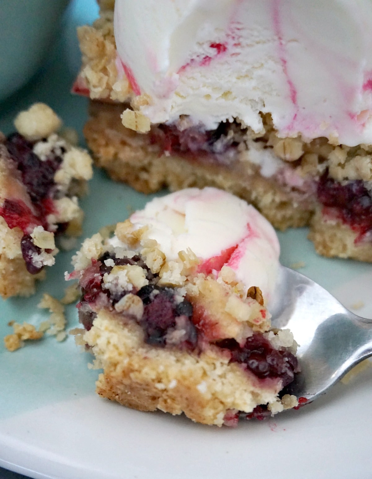 Close-up shoot of a spoonful of fruit crumble and ice cream