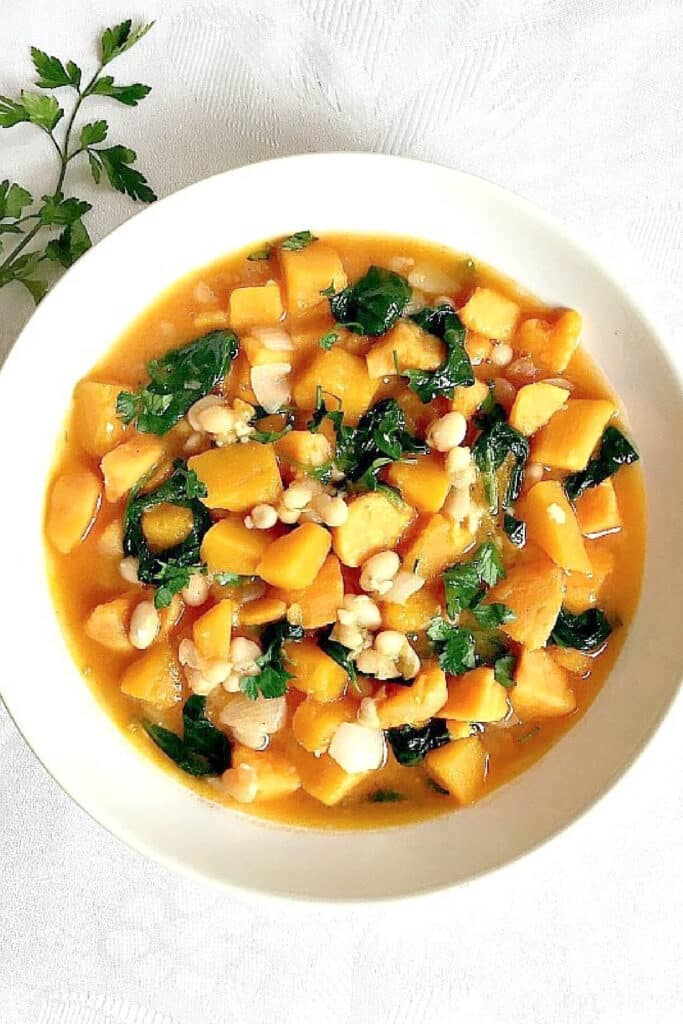 Overhead shoot of a white bowl with butternut squash and sweet potato stew