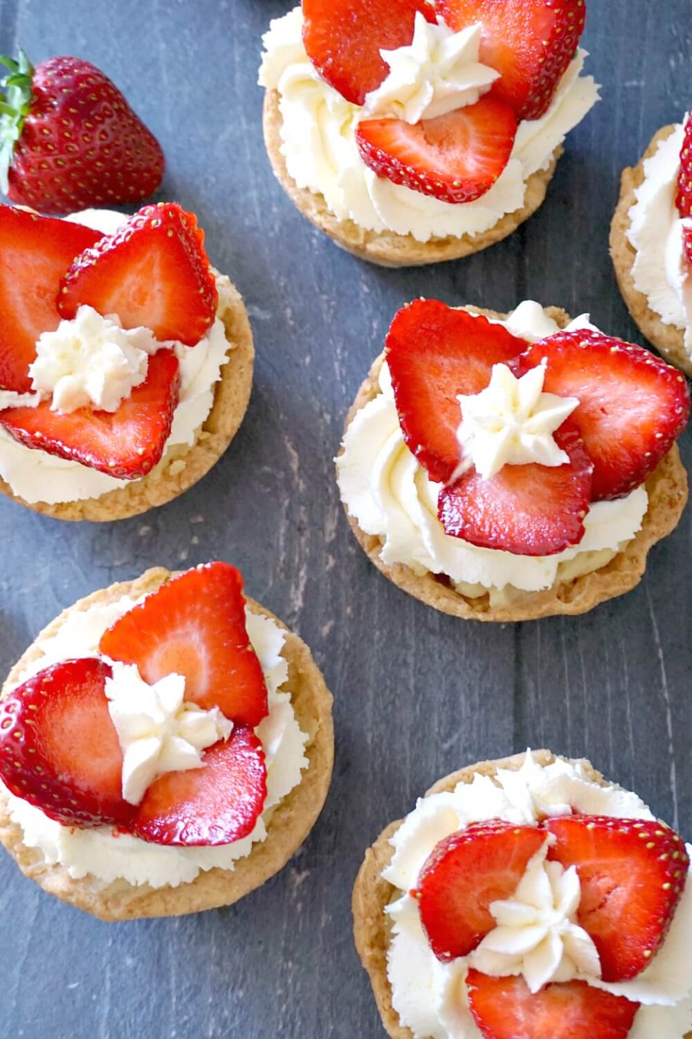 Overhead shoot of 6 strawberry tartlets.
