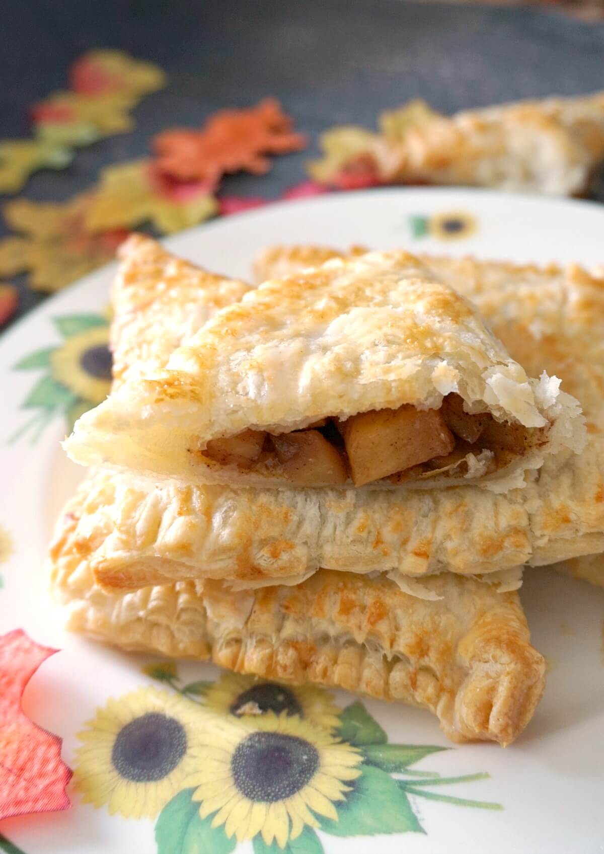 Half of an apple turnover on top of 2 whole ones.