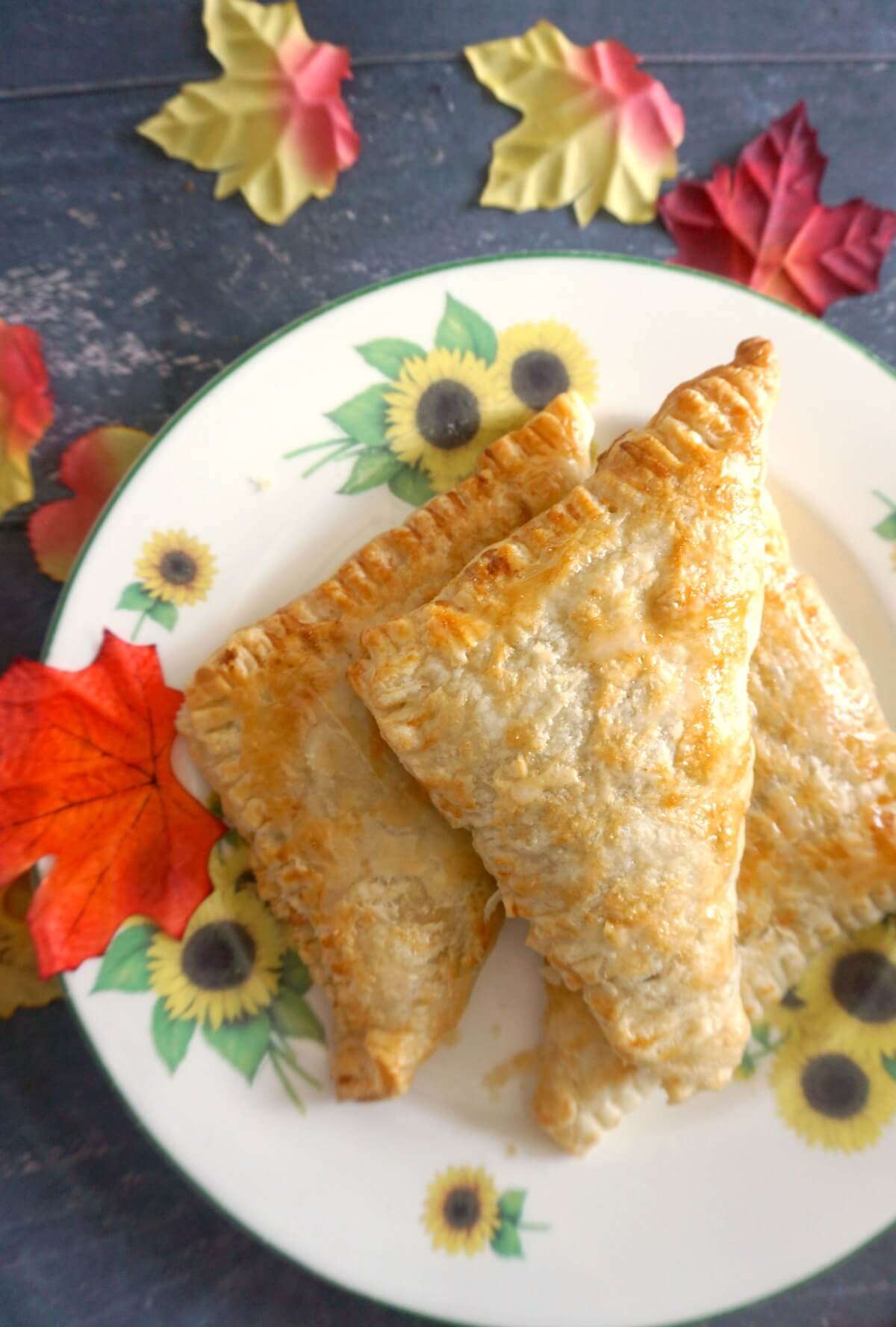 2 apple turnovers on a large plate.