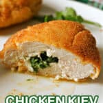 Half of a chicken Kiev on a white plate.