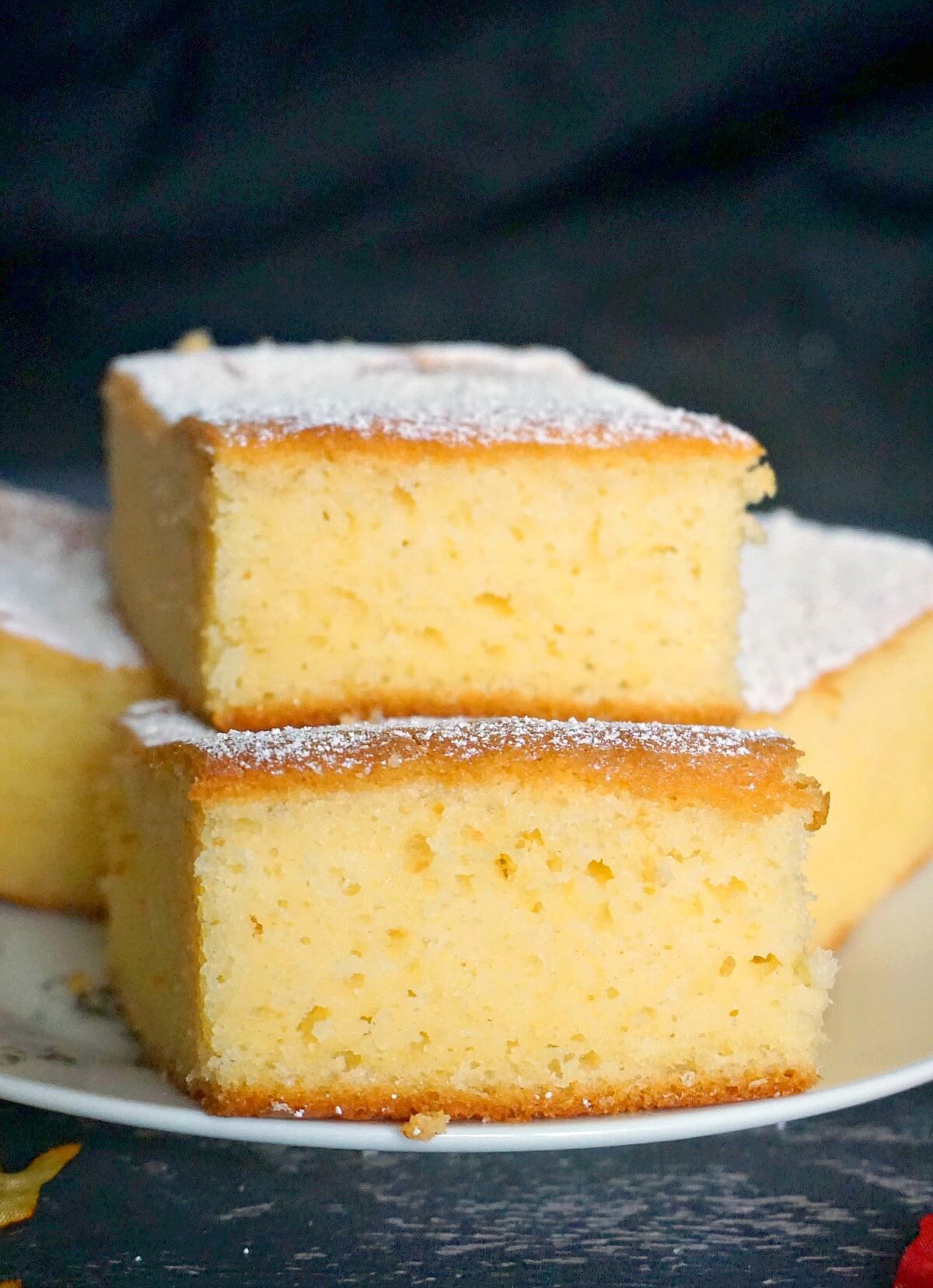 A stack of 2 slices of cornbread on a white plate