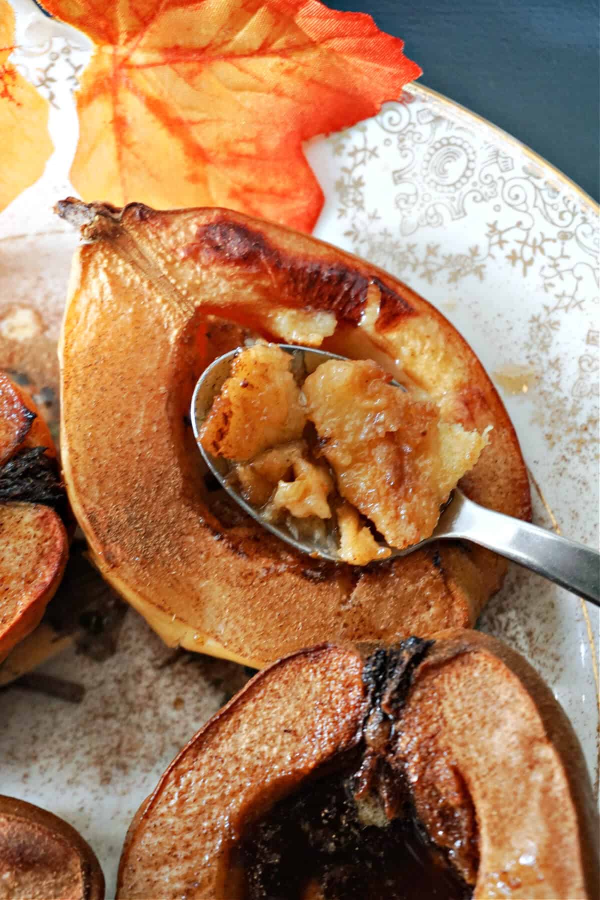 Half a baked quince with a spoonful of quince resting on it.