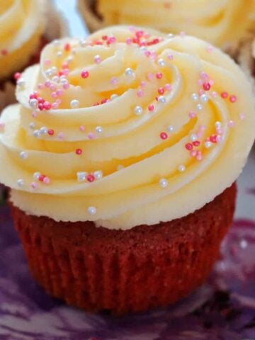 A red velvet cupcake on a pink plate