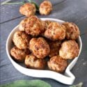 A white bowl of sausage stuffing balls