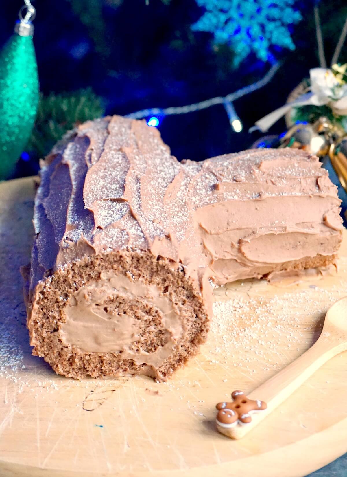 A chocolate yule log on a wooden board.