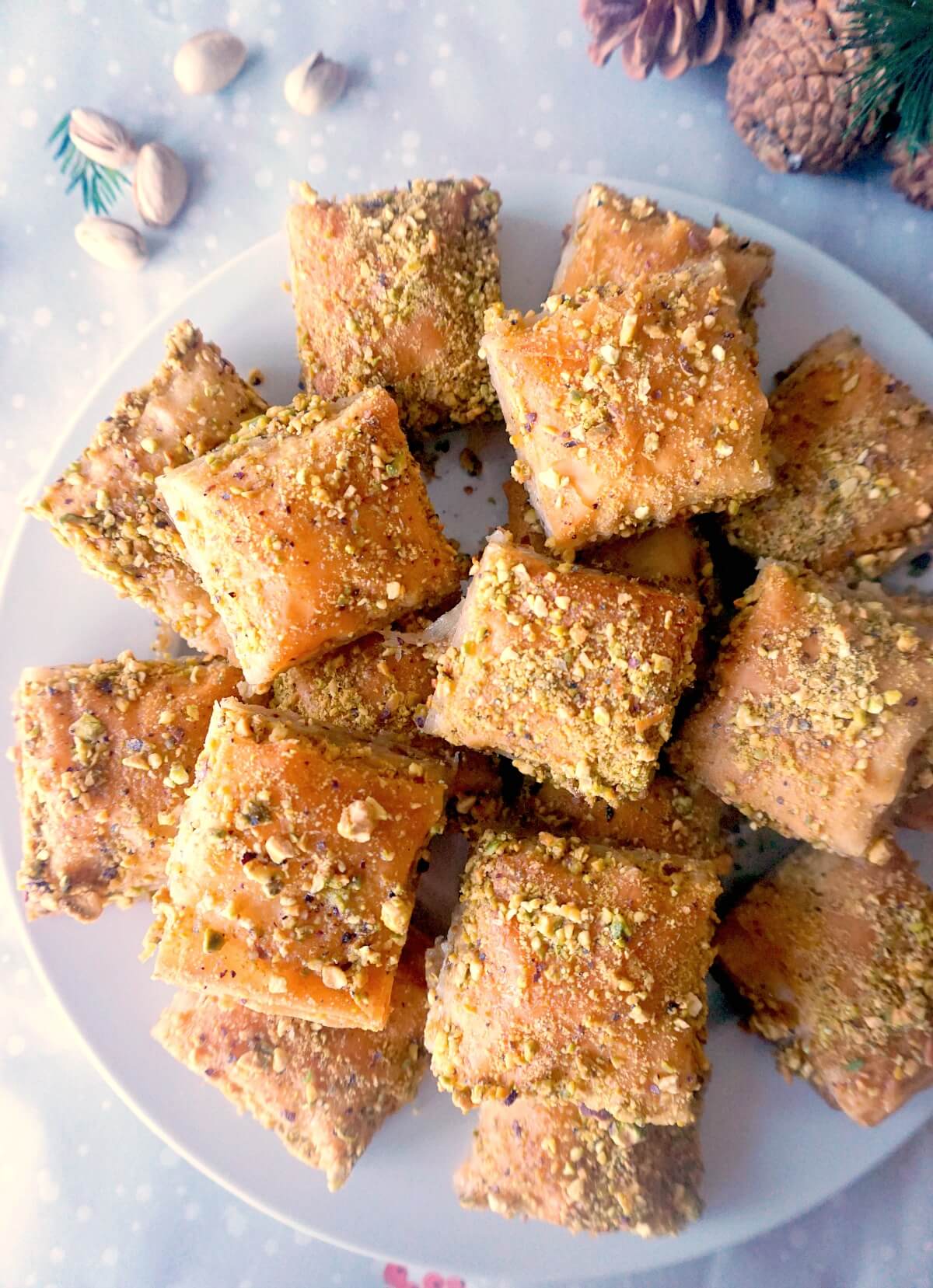 Overhead shoot of a white plate with baklava slices.