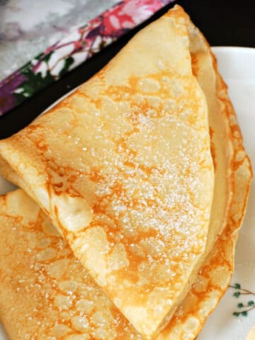 A plate with 2 crepes folded in quarter