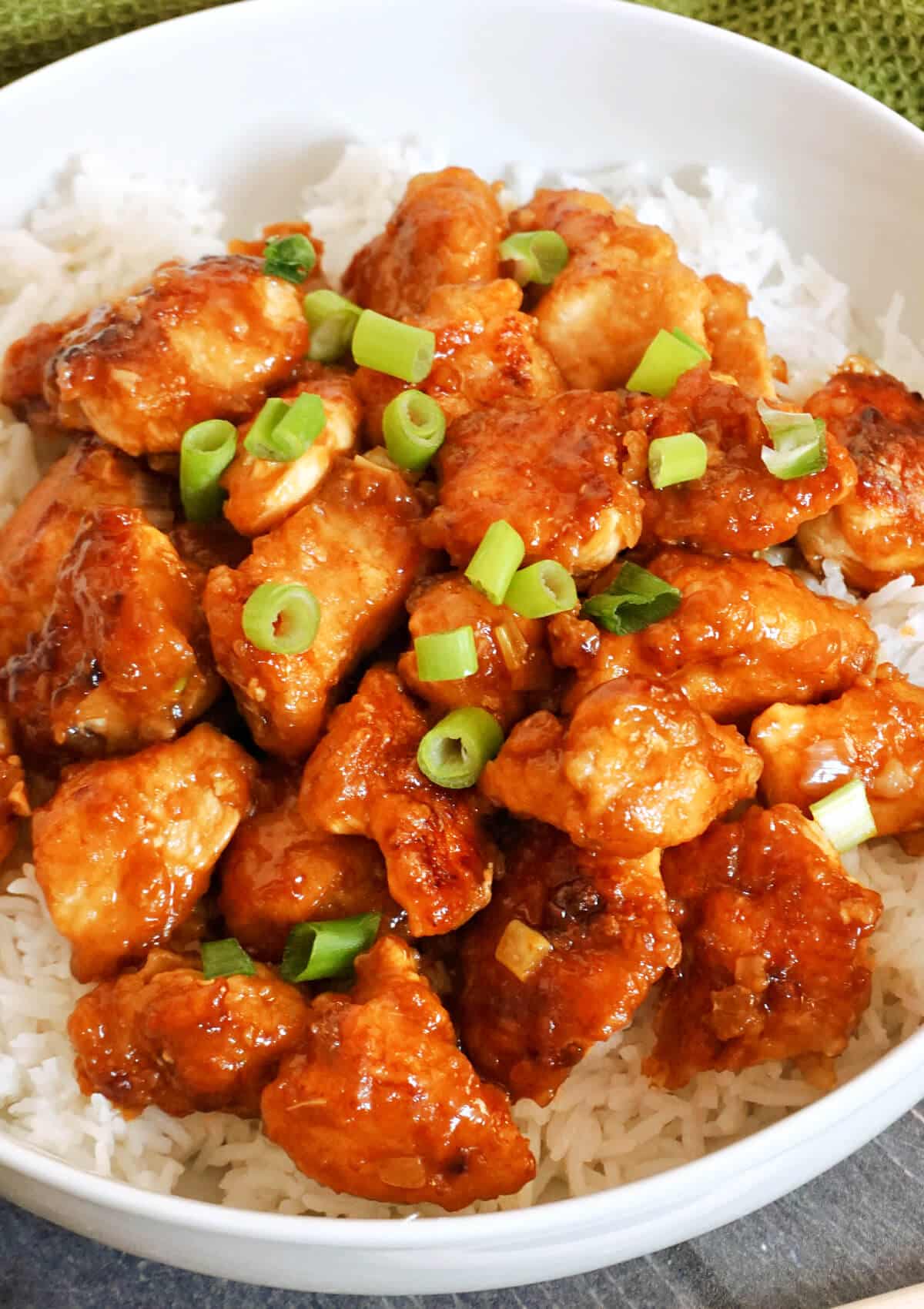 Orange chicken pieces on a bed of rice.