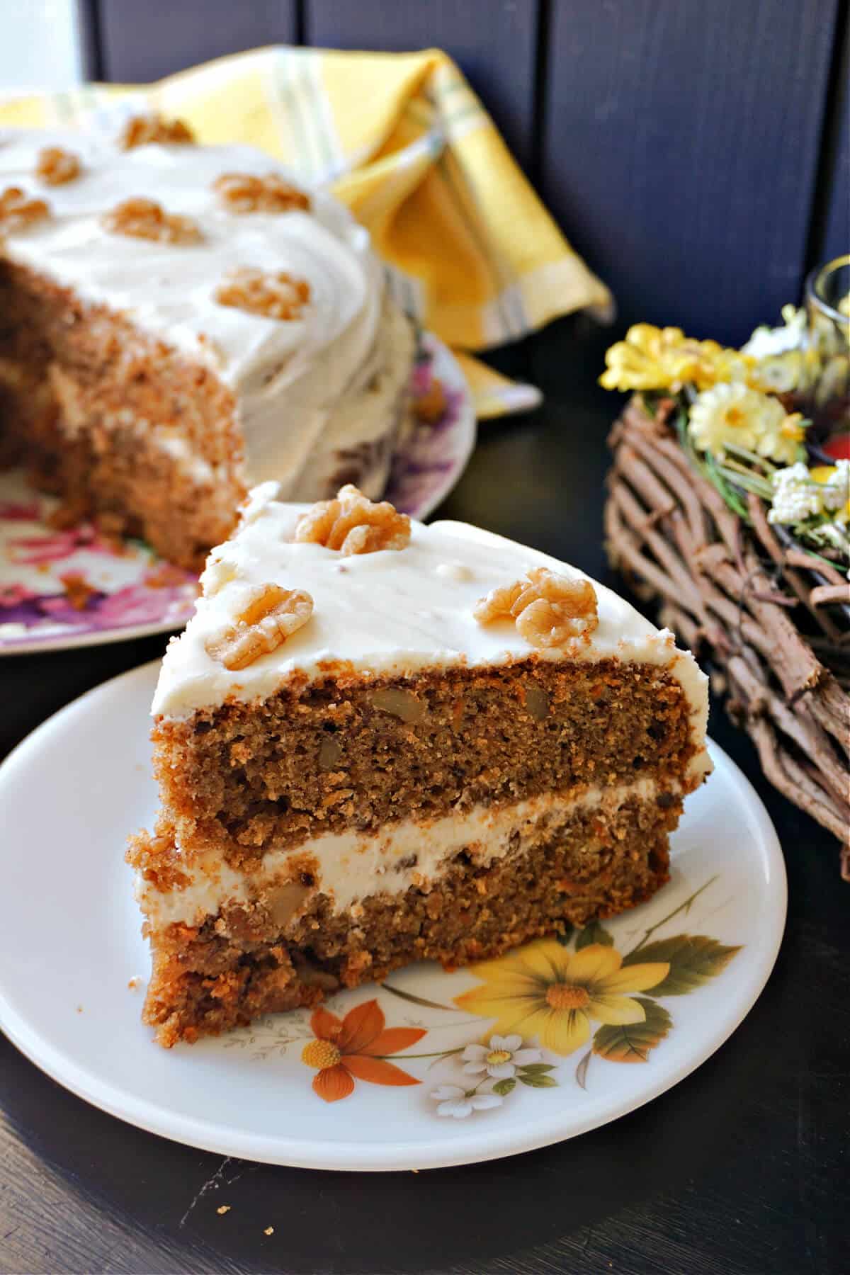 A slice of carrot cake on a white plate.