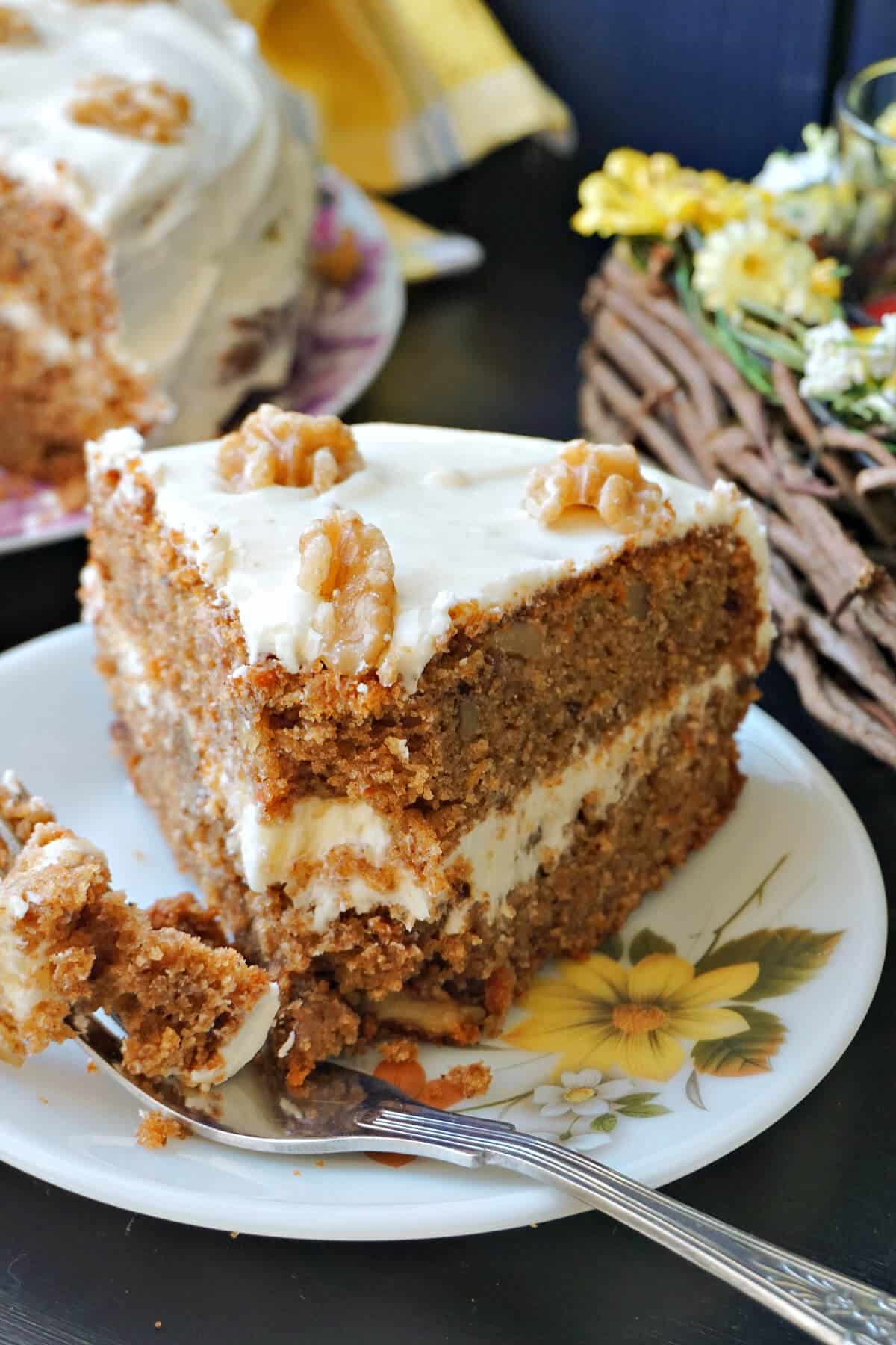 A slice of carrot cake on a white plate.