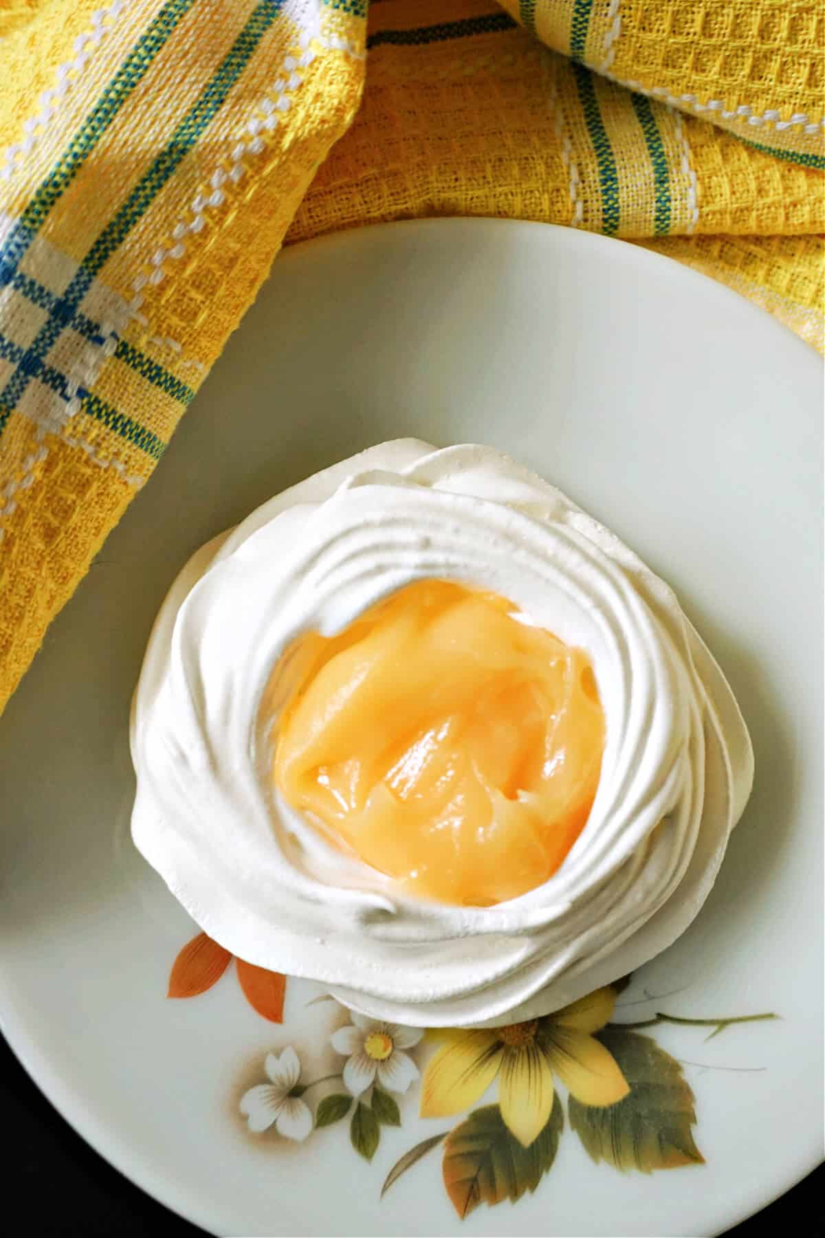 Overhead shoot of a meringue shell filled with lemon curd.