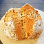 A loaf of soda bread on a wooden board
