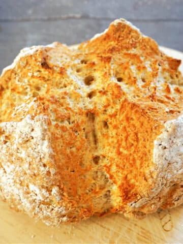 A loaf of soda bread on a wooden board